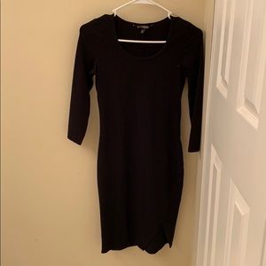 Black midway length dress with small slit.